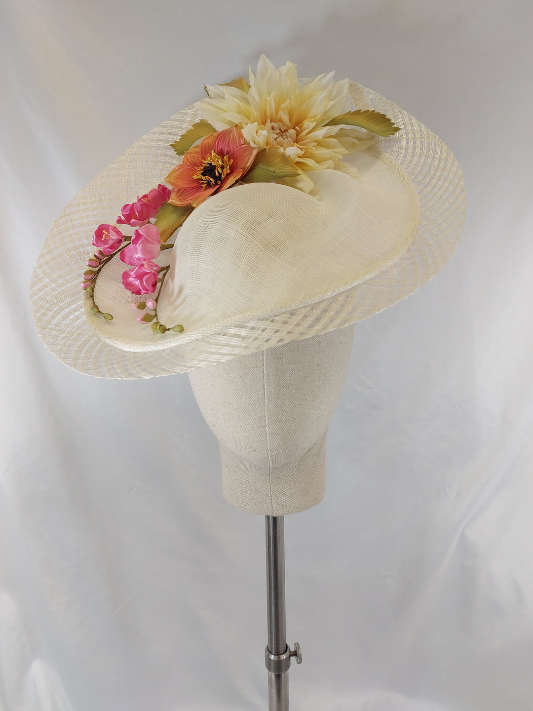 White hat with floral decorations on a white background