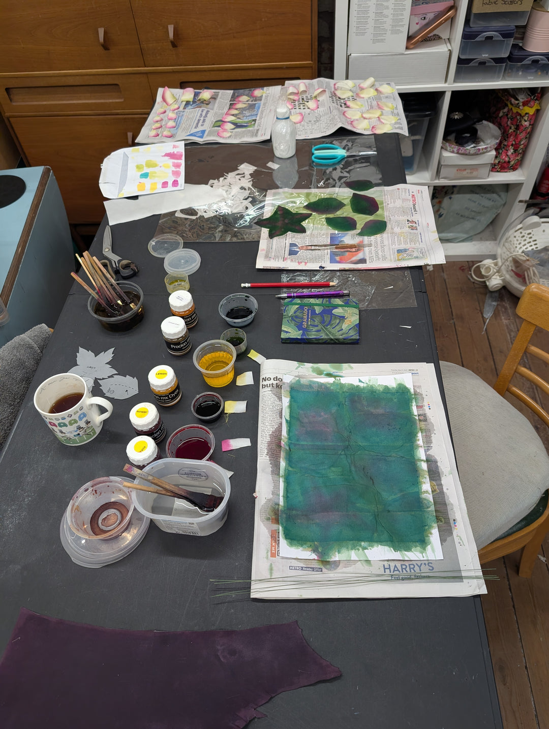 Millinery workspace with painting materials on a table