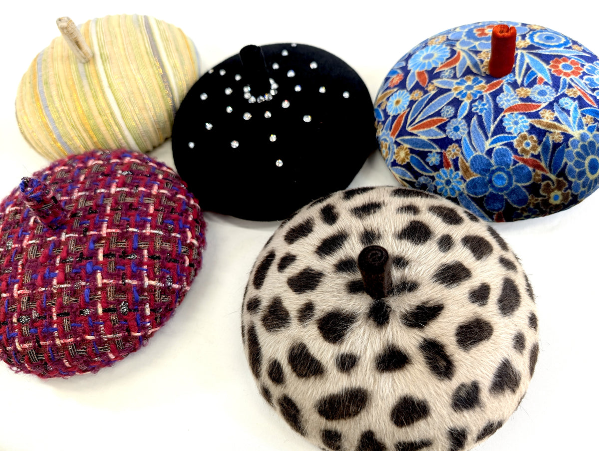 Collection of colourful hats on a white background