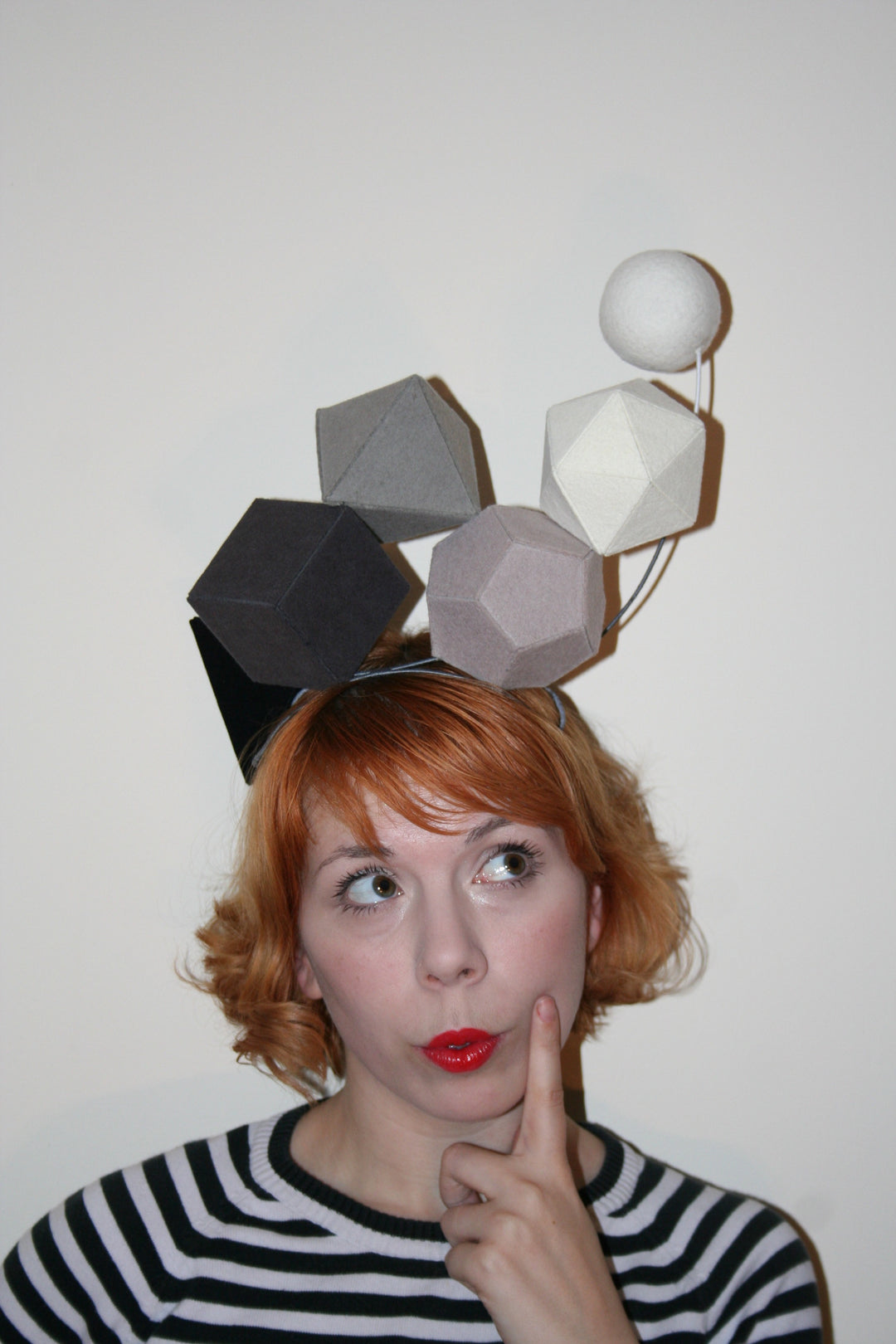 Giulia, founder and designer, wearing fun geometric hat pulling a face
