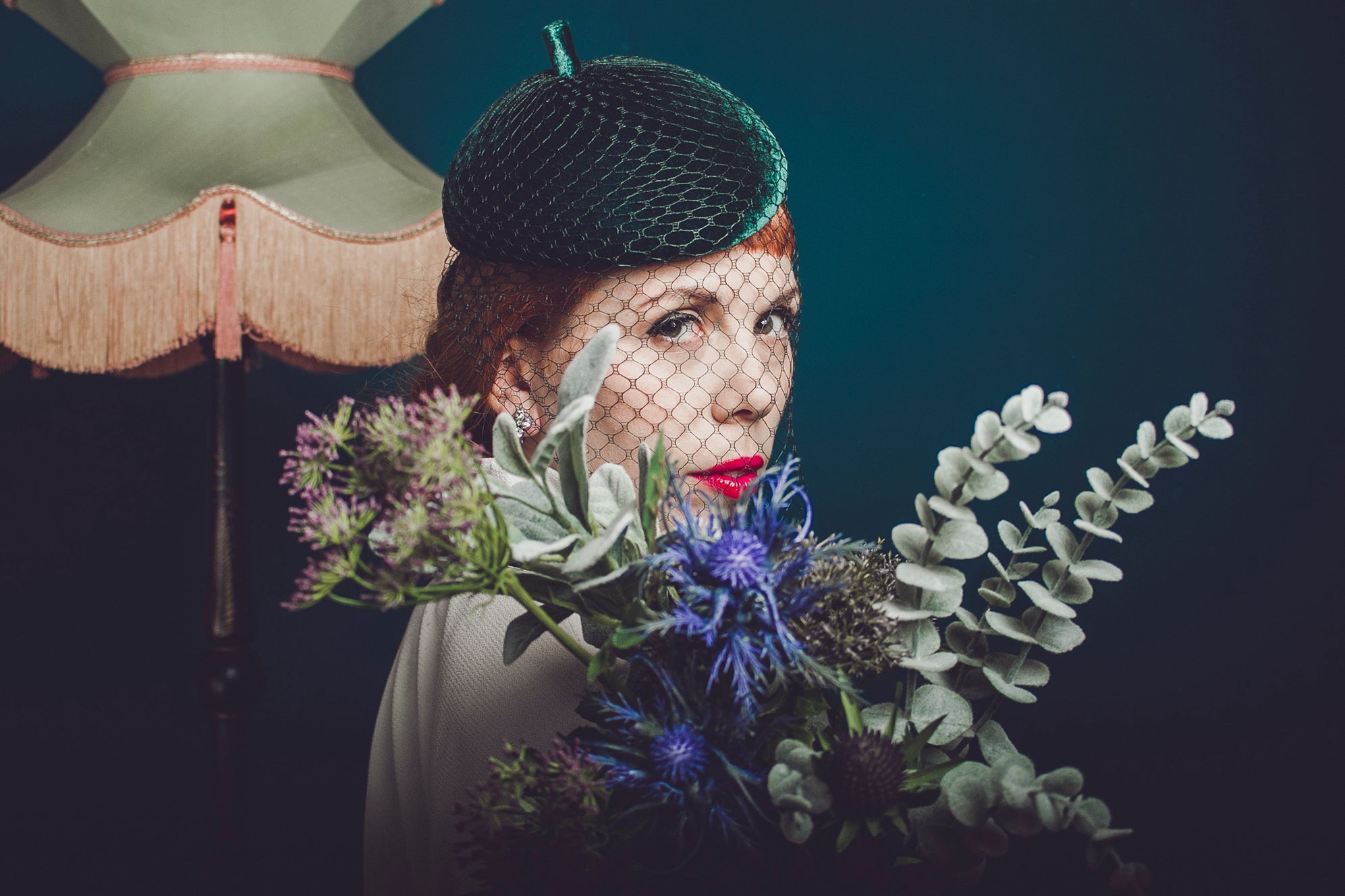 Woman holding a bouquet of flowers with a dark background