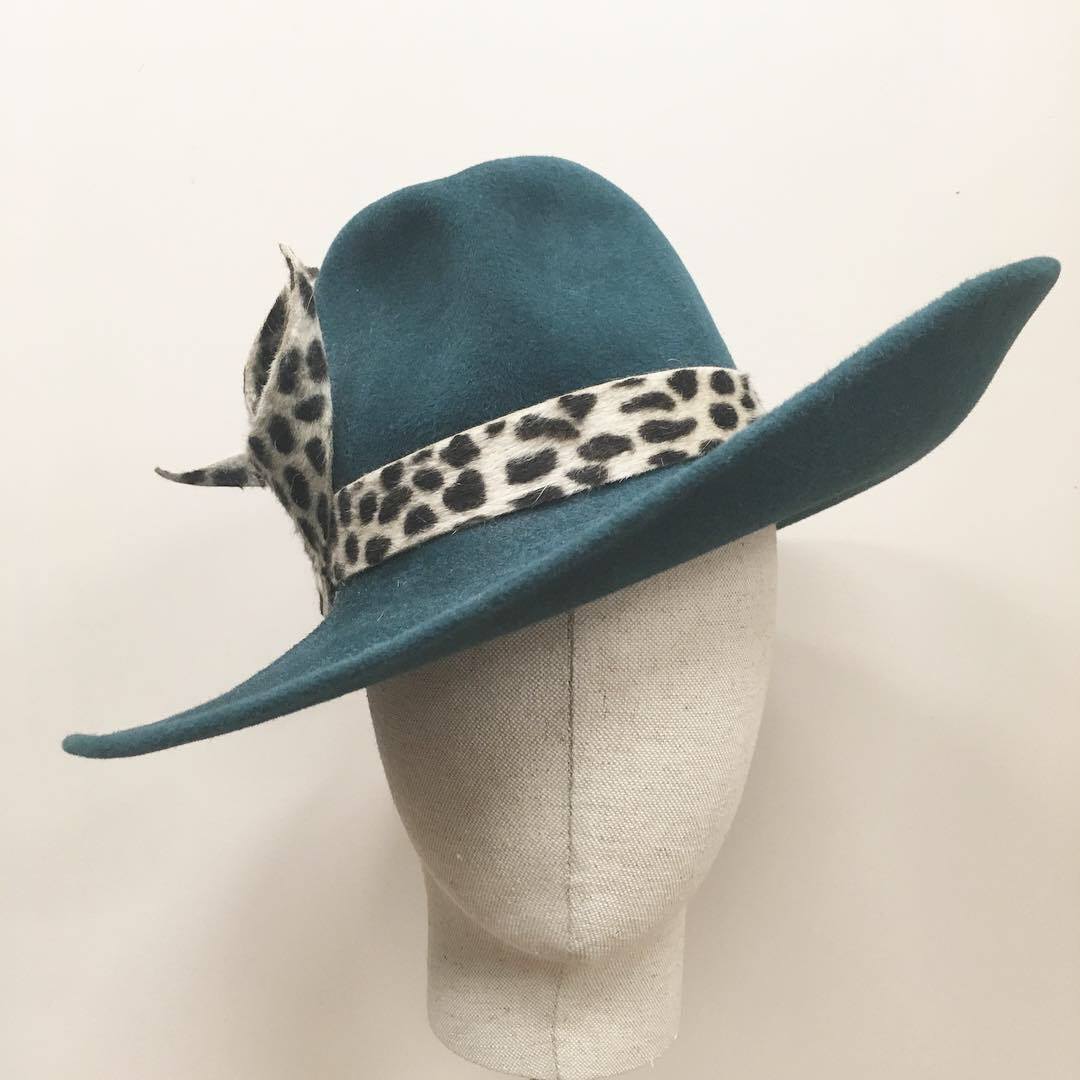 large brim green hat on a mannequin